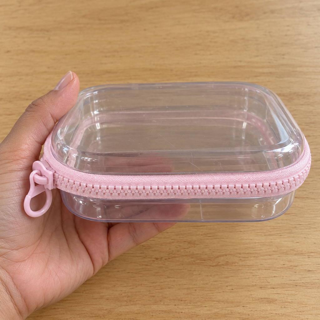 Estuche rígido transparente con cierre · rosa o azul